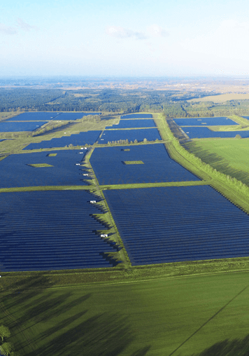 Large Solar Farm with green ground and blue sky