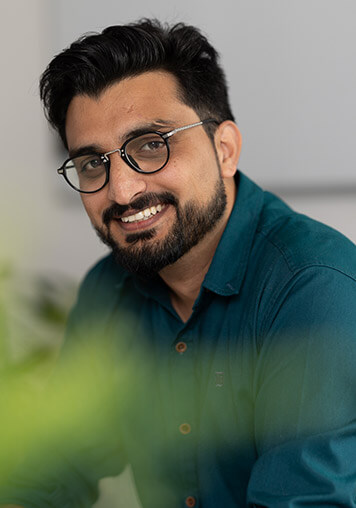 A BELECTRIC employee working on system design optimisation smiles into the camera