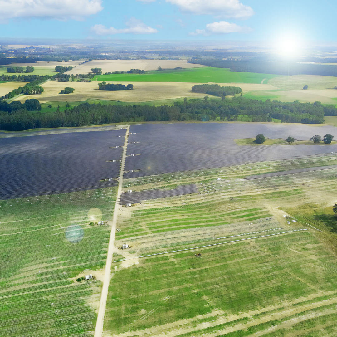 solar power plant during construction with green fields and trees seen from above