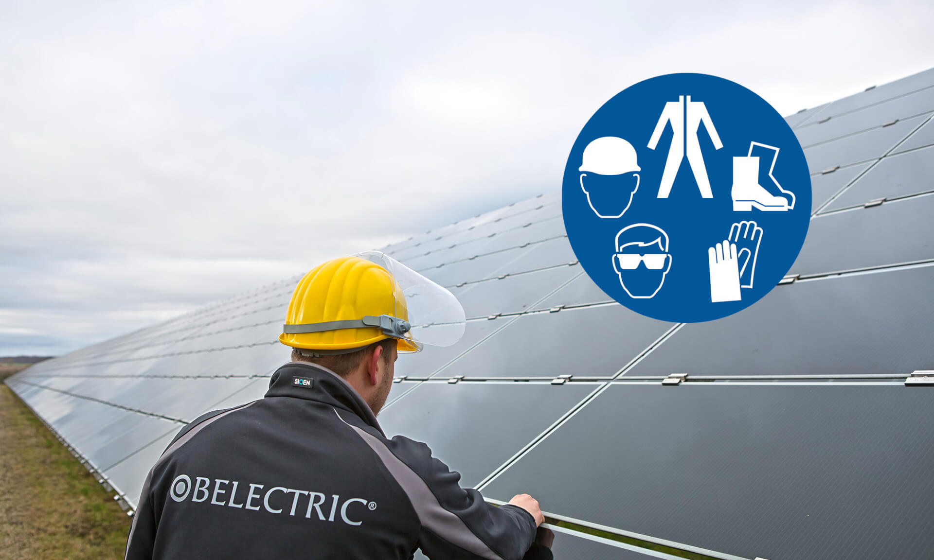 BELECTRIC empoylee with a construction helmet who is working on the modules of a solar farm