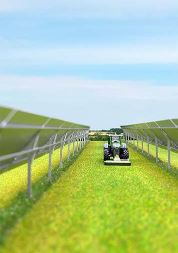 An agrivoltaics model where a tractor passes through in between two module rows of a solar farm