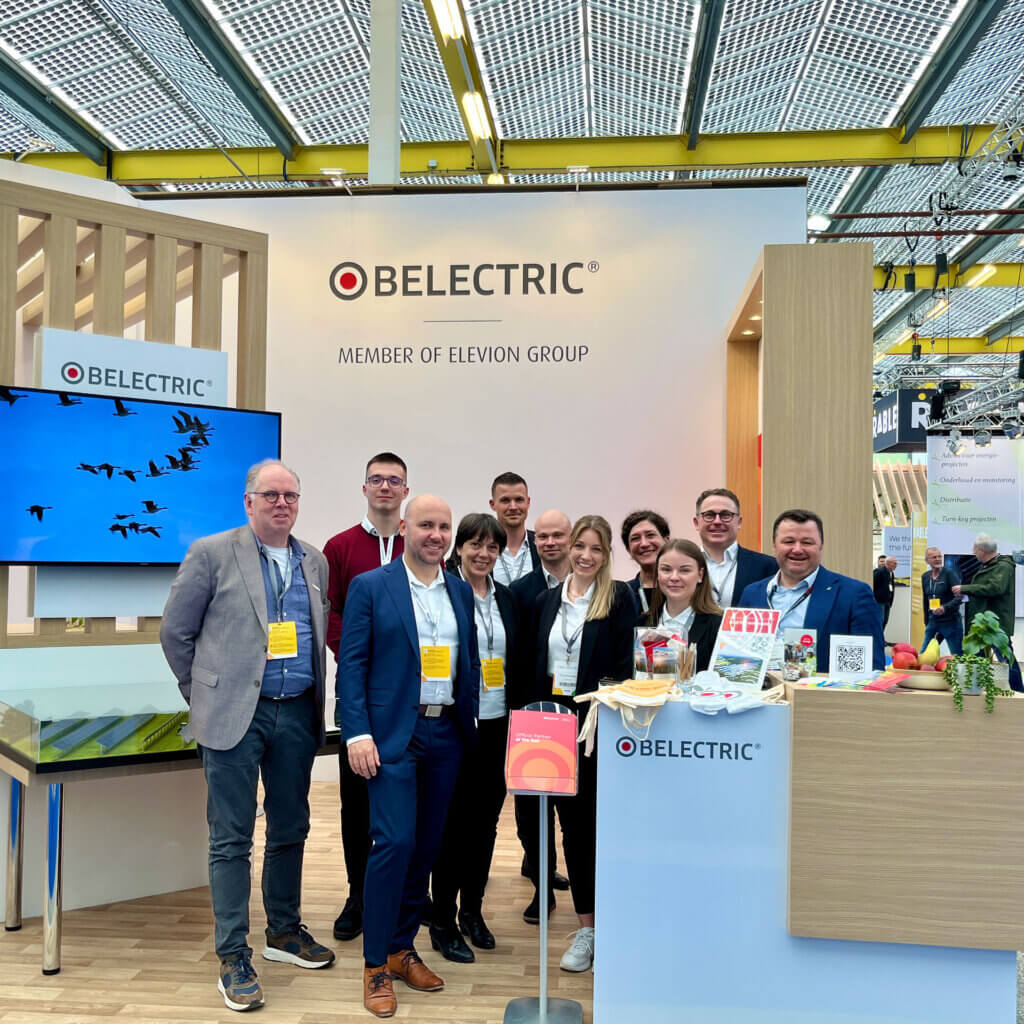 BELECTRIC employees stand in front of a trade fair booth at Solar Solutions Amsterdam