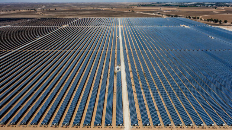 solar farm constructed by BELECTRIC Israel with fields and trees in the back